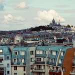 blue and brown concrete building under white clouds during daytime