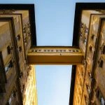a view looking up at two tall buildings