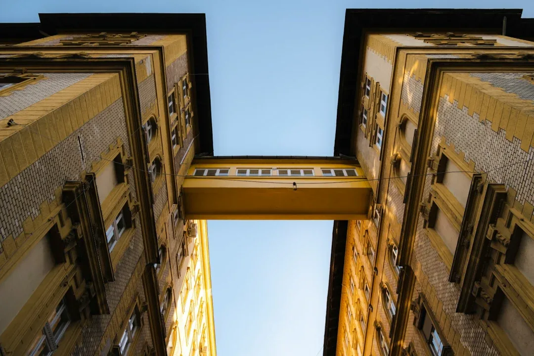 a view looking up at two tall buildings